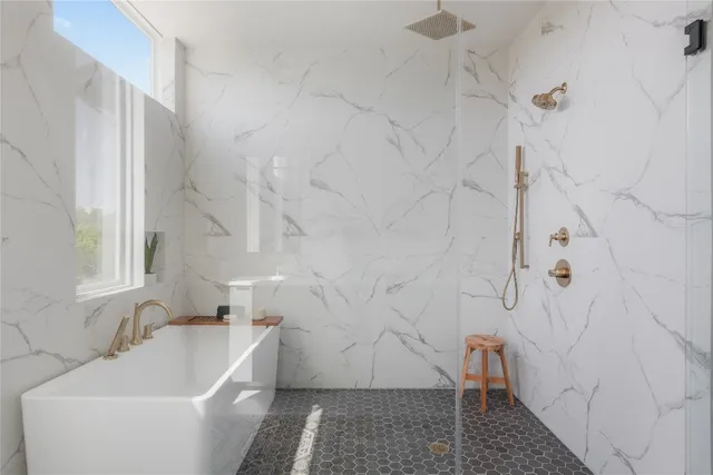 a bathroom with a sink and bathtub with shower
