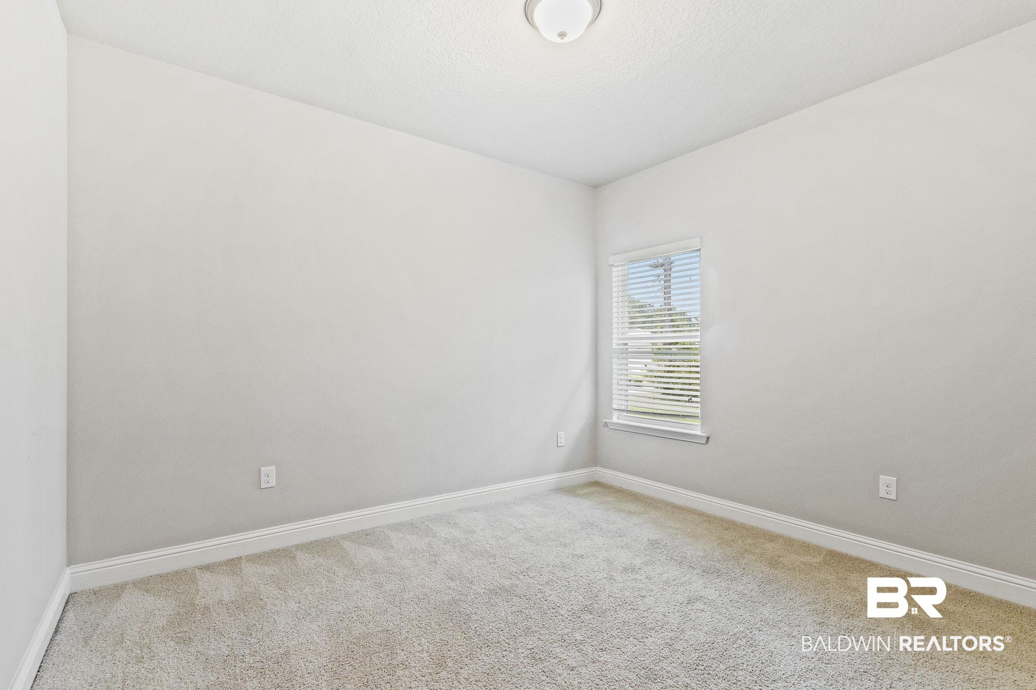 31643 Kestrel Loop Daphne, AL 36527 - Photo 32 of 59 Carpeted spare room with a textured ceiling