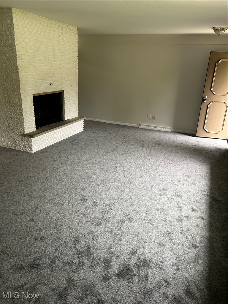 8223 Montello Road Independence, OH 44131 - Photo 9 of 28 Unfurnished living room with carpet flooring and a brick fireplace