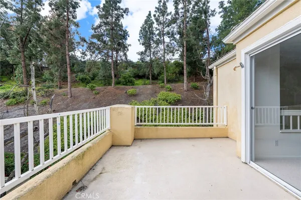 a view of a house with wooden fence