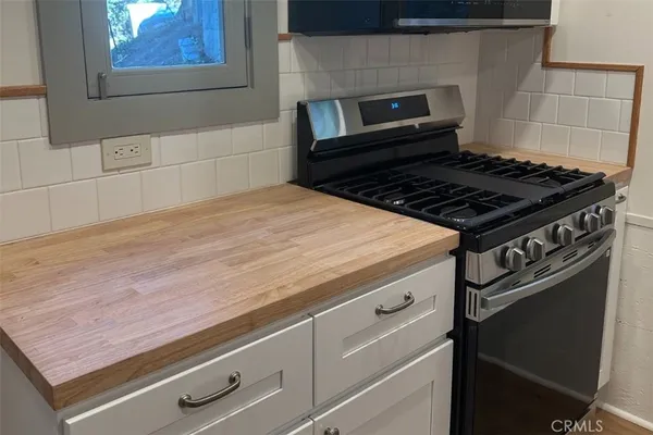 a stove top oven sitting inside of a kitchen