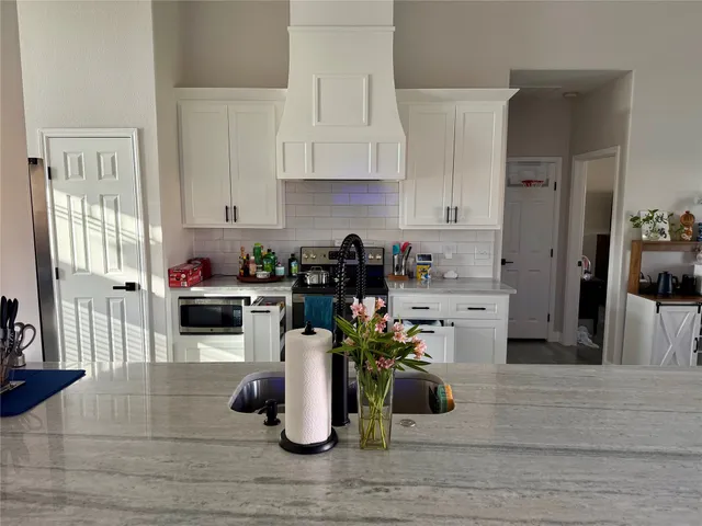 a kitchen with a sink and cabinets