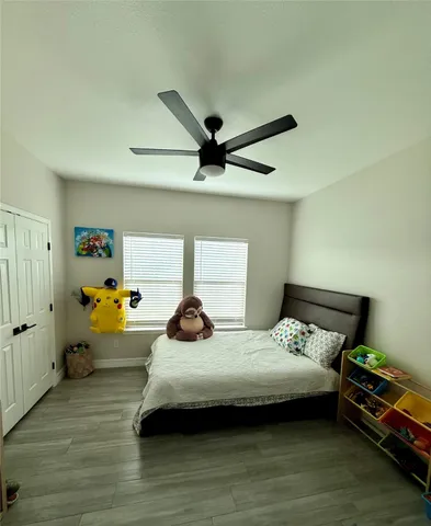 a bedroom with a bed and wooden floor