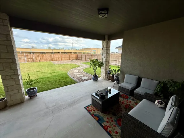 a living room with patio furniture and garden