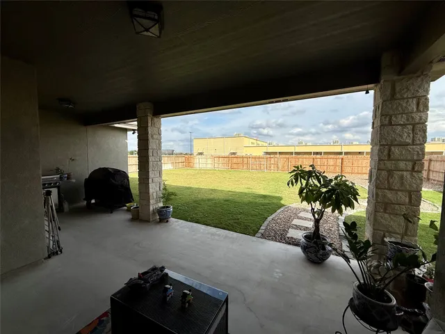 a very nice looking room with a large window and yard