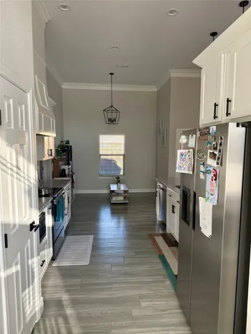 a kitchen with stainless steel appliances a refrigerator and a stove