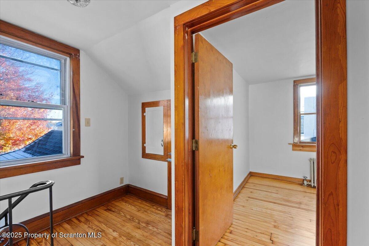 131 Stephenson Street Duryea, PA 18642 - Photo 15 of 28 a view of a hallway with wooden floor and a bathroom