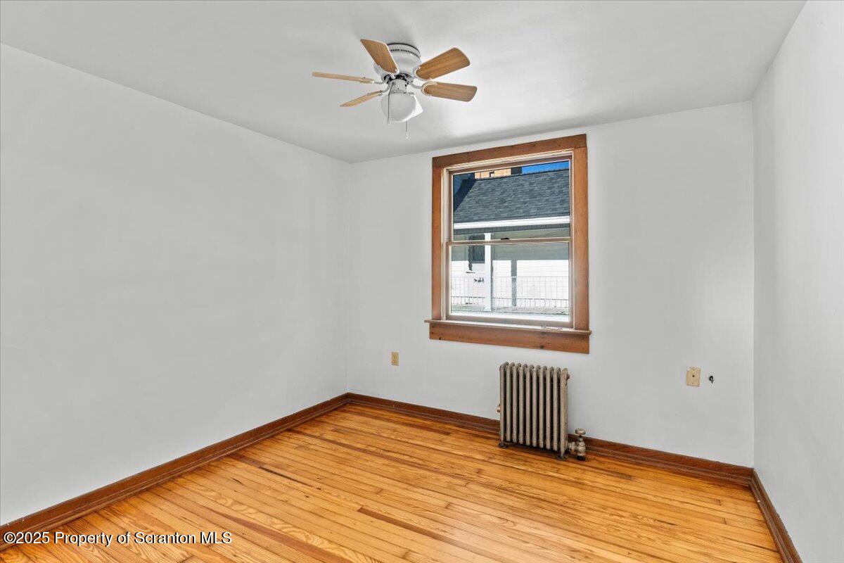 131 Stephenson Street Duryea, PA 18642 - Photo 16 of 28 a view of empty room with wooden floor and fan