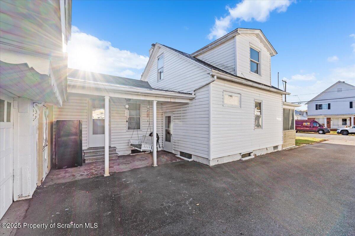 131 Stephenson Street Duryea, PA 18642 - Photo 26 of 28 a view of a house with a barbeque and large trees