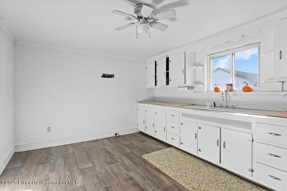 131 Stephenson Street Duryea, PA 18642 - Photo 4 of 28 a view of a kitchen with sink and dishwasher with wooden floor