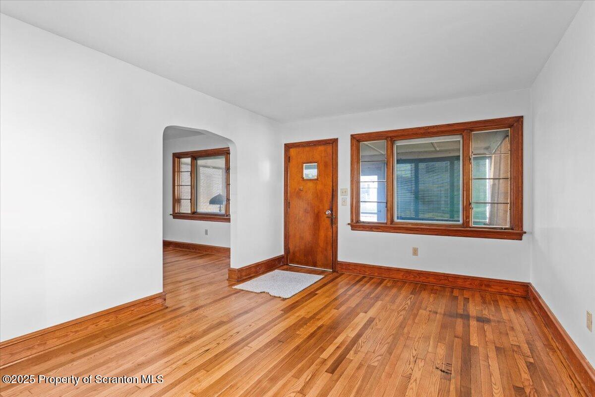 131 Stephenson Street Duryea, PA 18642 - Photo 6 of 28 a view of an empty room with wooden floor and a window