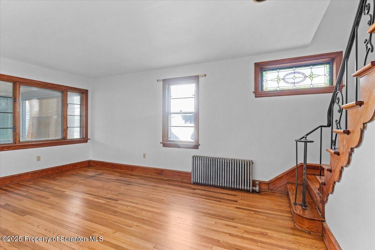 131 Stephenson Street Duryea, PA 18642 - Photo 7 of 28 a view of an empty room with wooden floor and a window