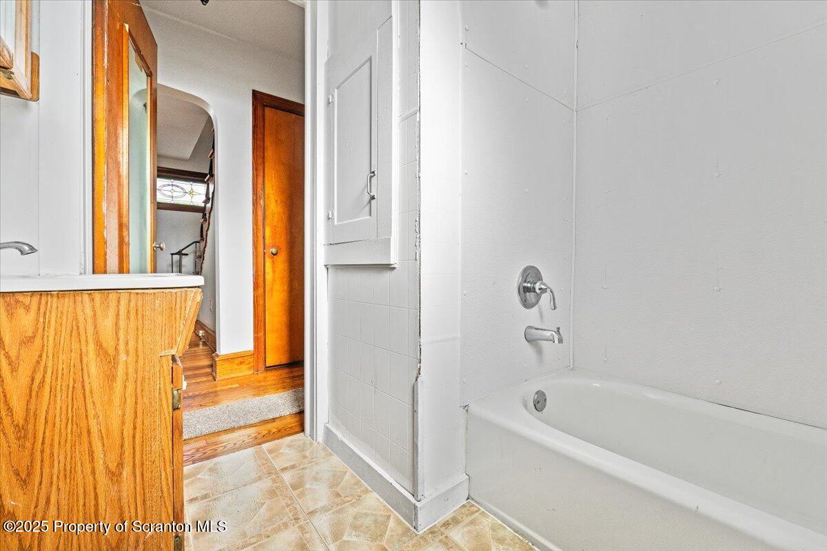 131 Stephenson Street Duryea, PA 18642 - Photo 10 of 28 a bathroom with a bathtub and a shower