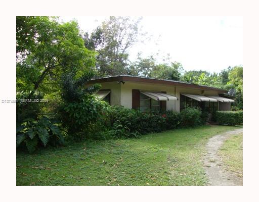 a view of a house with backyard sitting area and garden
