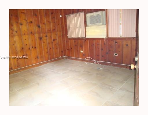 5942 Southwest 60th Street Miami, FL 33143 - Photo 2 of 14 a view of an empty room with wooden floor
