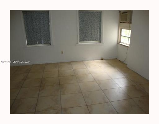 5942 Southwest 60th Street Miami, FL 33143 - Photo 3 of 14 a view of an empty room with windows and bathroom