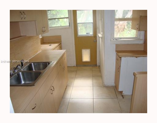 5942 Southwest 60th Street Miami, FL 33143 - Photo 6 of 14 a kitchen with a sink and a refrigerator