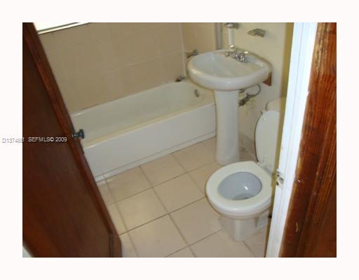 5942 Southwest 60th Street Miami, FL 33143 - Photo 8 of 14 a bathroom with a sink toilet and a mirror