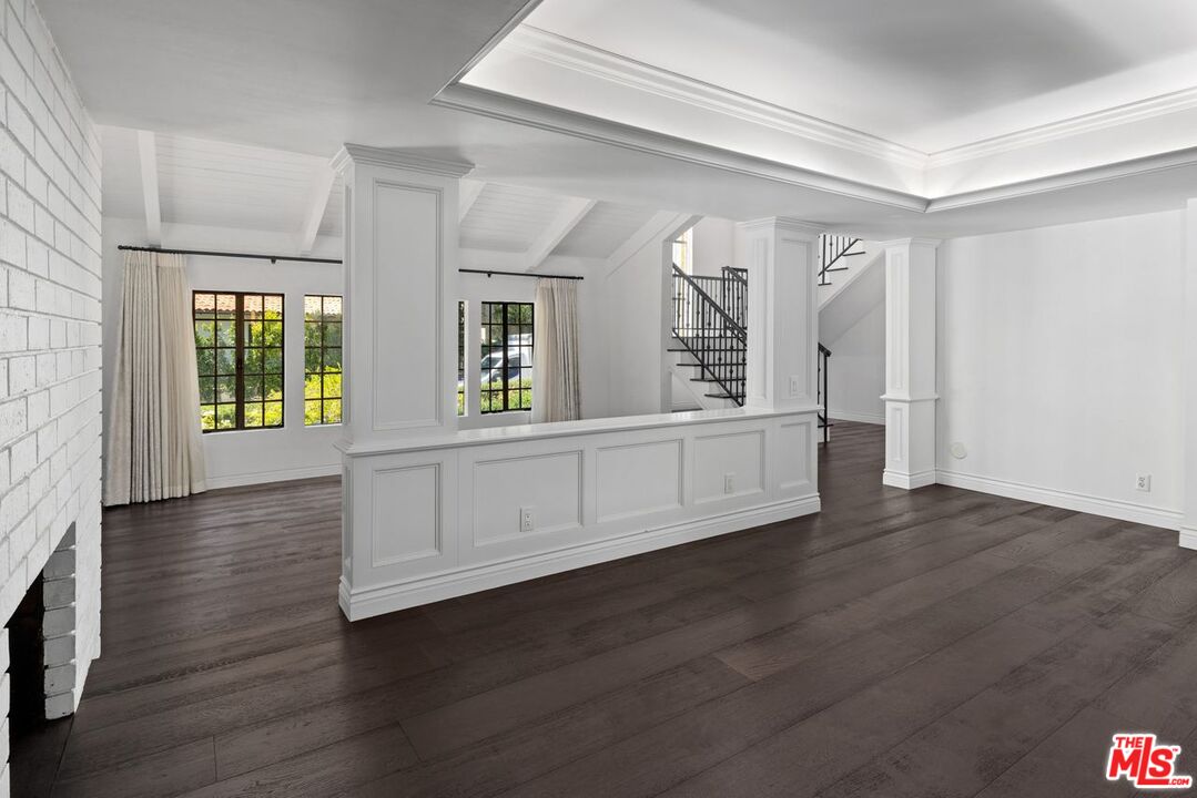 1060 Chantilly Road Los Angeles, CA 90077 - Photo 12 of 40 an empty room with wooden floor and windows