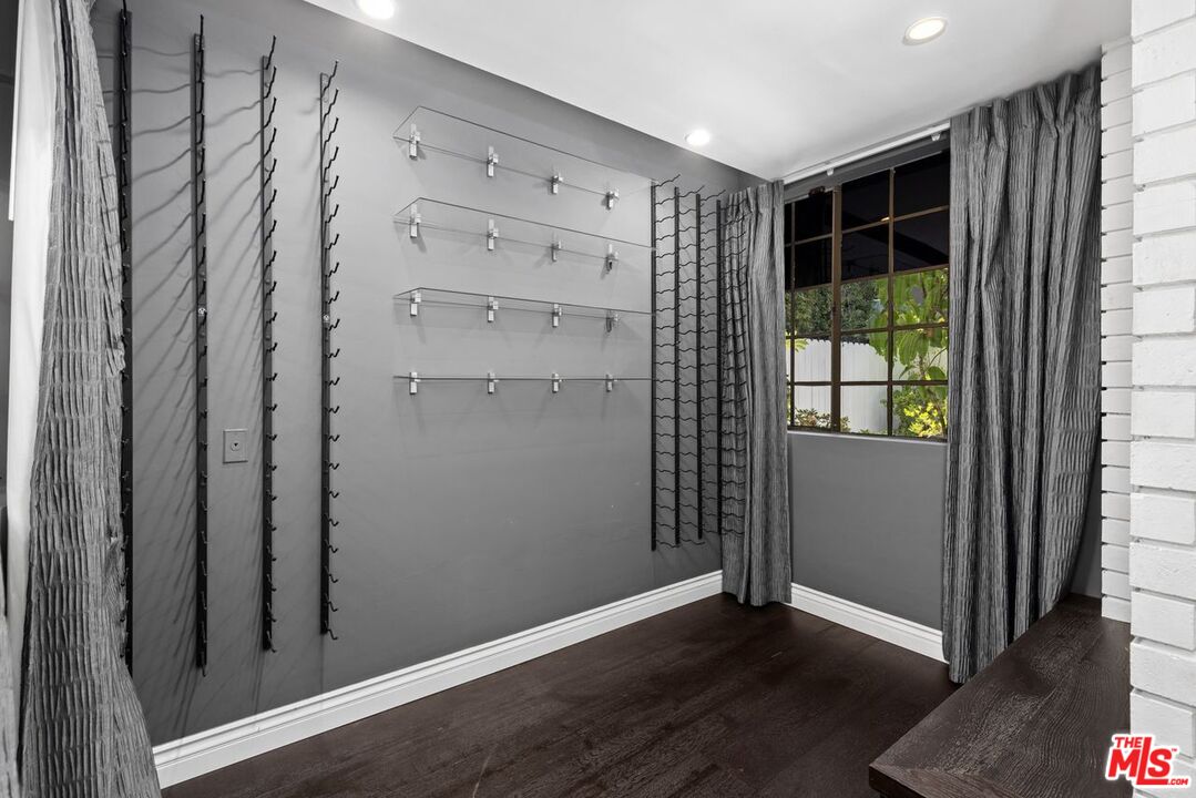 1060 Chantilly Road Los Angeles, CA 90077 - Photo 13 of 40 an empty room with wooden floor and windows