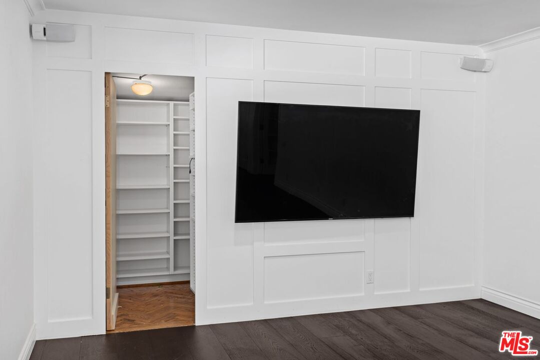 1060 Chantilly Road Los Angeles, CA 90077 - Photo 15 of 40 a living room with a fireplace and wooden floor