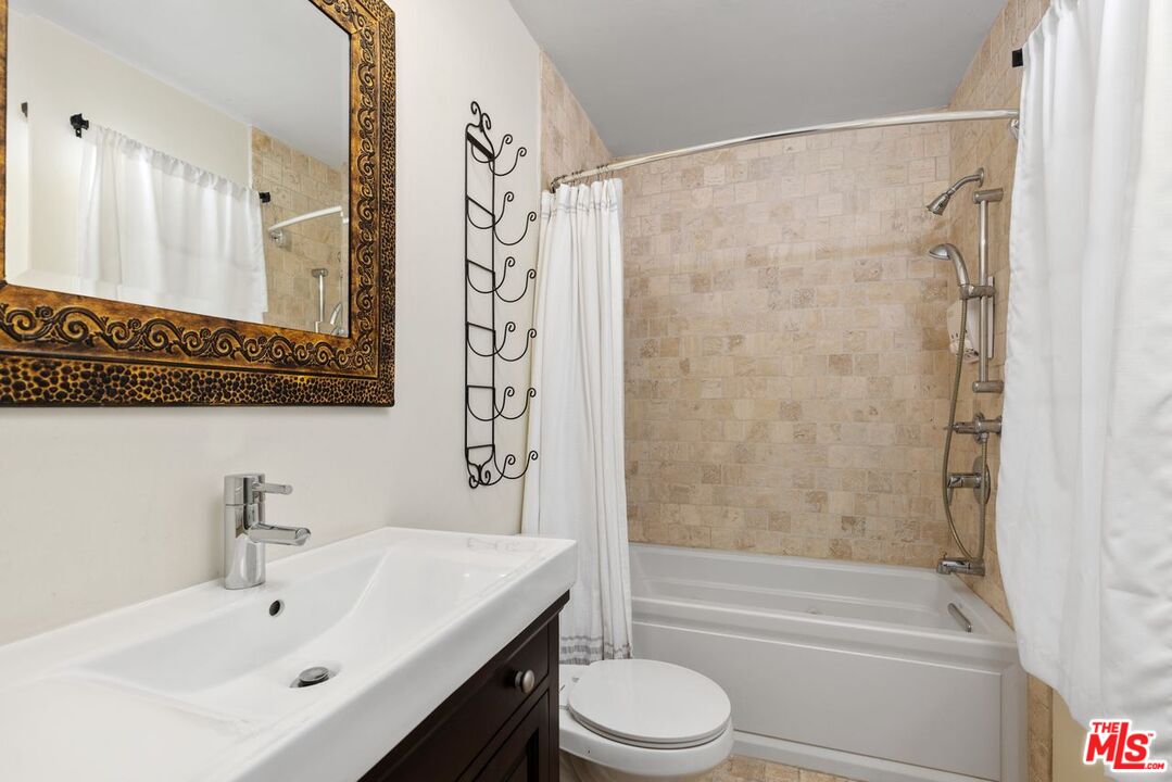 1060 Chantilly Road Los Angeles, CA 90077 - Photo 22 of 40 a bathroom with a sink a toilet and shower