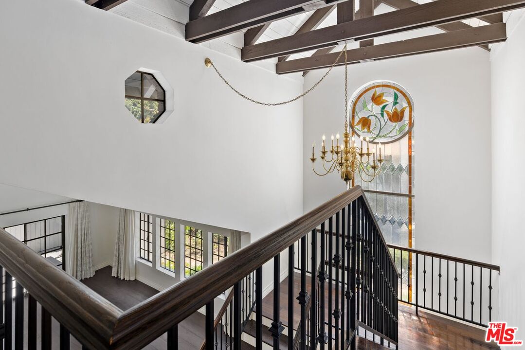 1060 Chantilly Road Los Angeles, CA 90077 - Photo 27 of 40 a view of a hallway with windows
