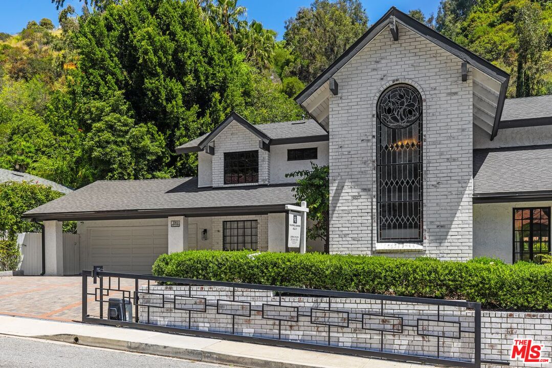 1060 Chantilly Road Los Angeles, CA 90077 - Photo 3 of 40 a front view of a house with garden