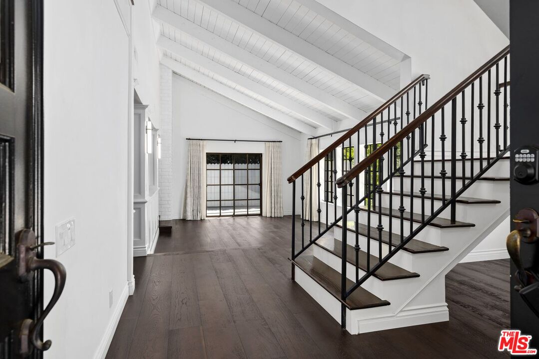 1060 Chantilly Road Los Angeles, CA 90077 - Photo 6 of 40 a view of entryway with wooden floor and stairs