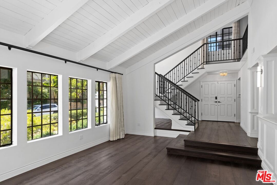 1060 Chantilly Road Los Angeles, CA 90077 - Photo 7 of 40 a view of staircase with white walls and windows