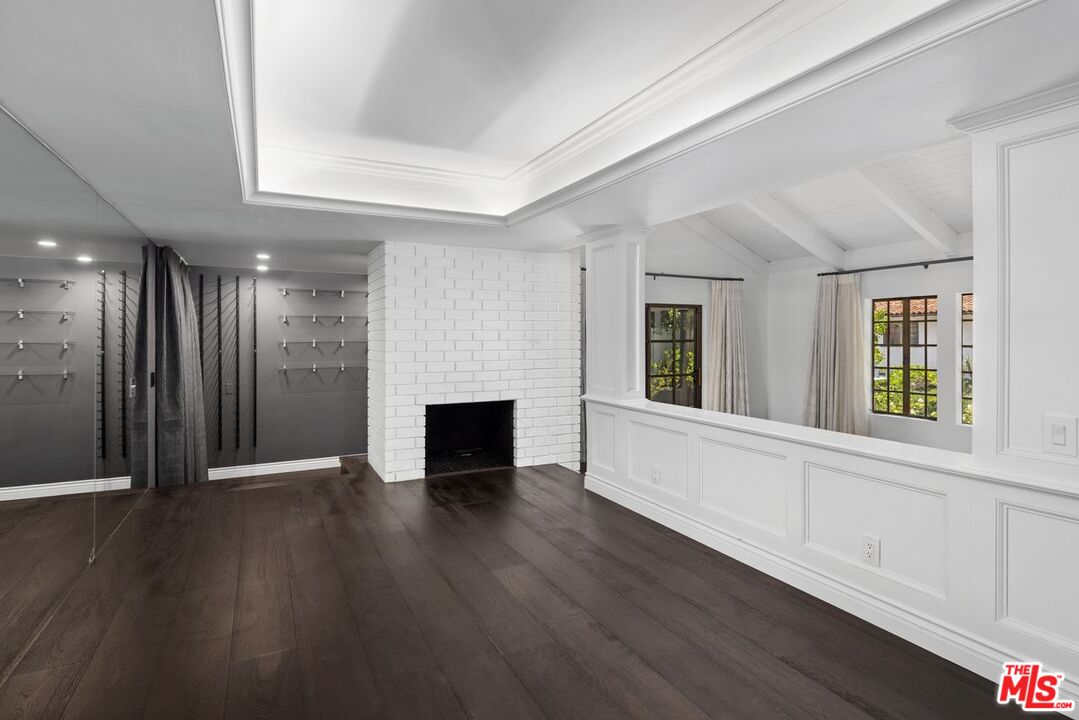 1060 Chantilly Road Los Angeles, CA 90077 - Photo 10 of 40 an empty room with wooden floor and windows