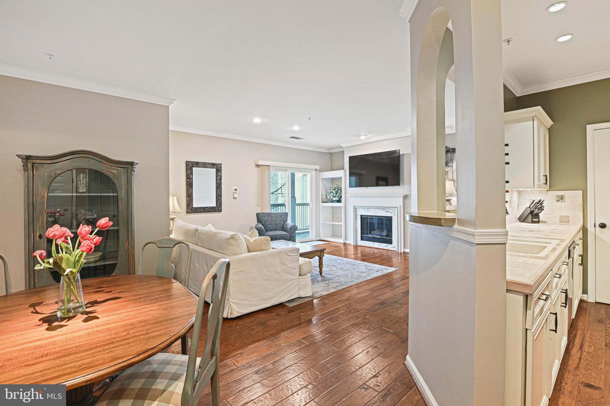 1701 Lake Shore Crest Drive, Unit 24 Reston, VA 20190 - Photo 1 of 43 a living room with furniture fireplace and flat screen tv
