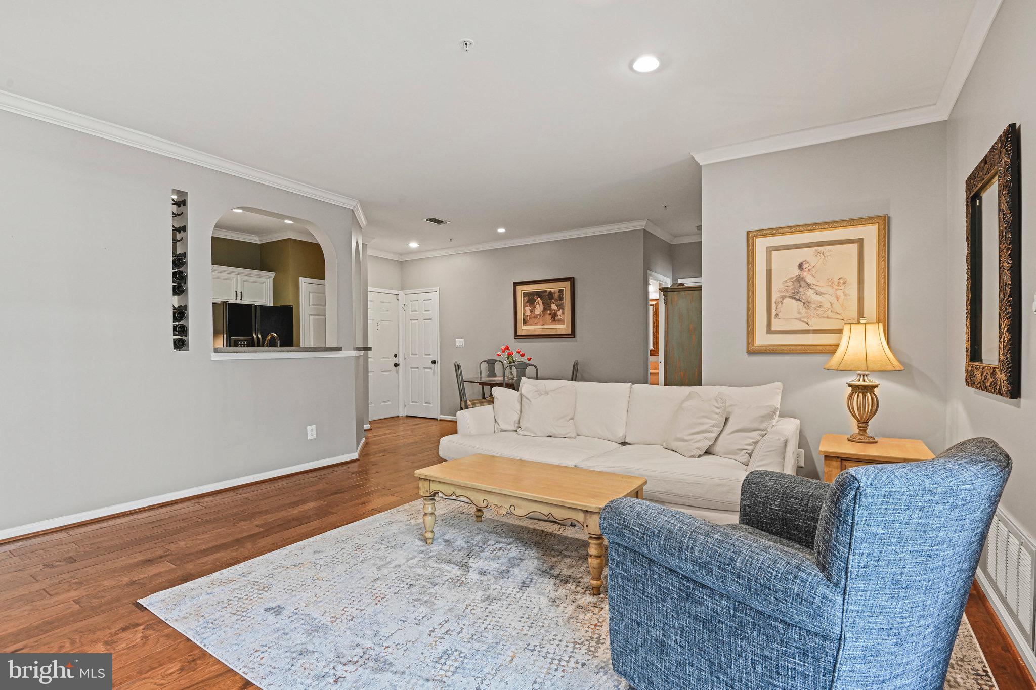 1701 Lake Shore Crest Drive, Unit 24 Reston, VA 20190 - Photo 11 of 33 a living room with furniture and a wooden floor