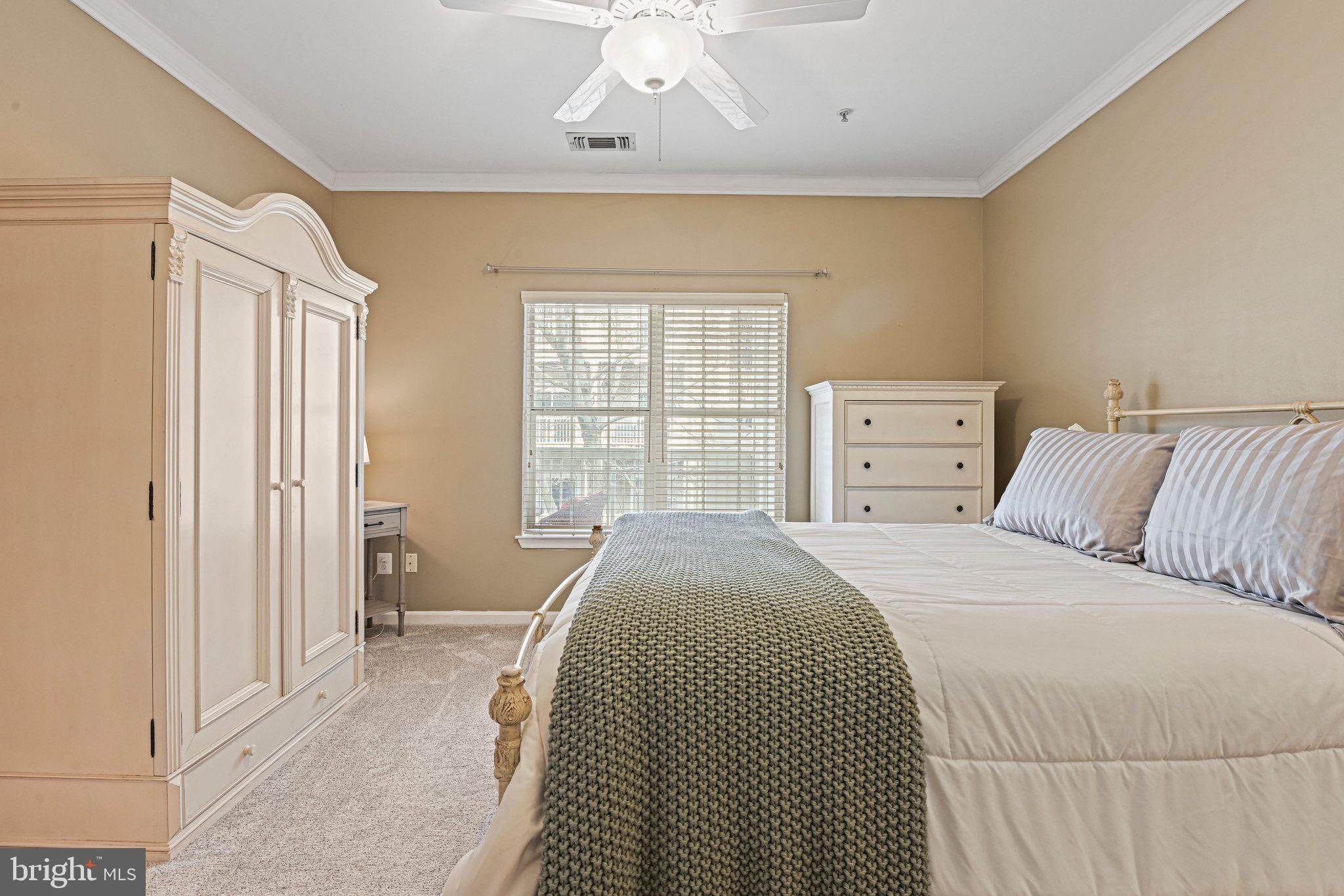 1701 Lake Shore Crest Drive, Unit 24 Reston, VA 20190 - Photo 16 of 43 a bedroom with a large bed and a window