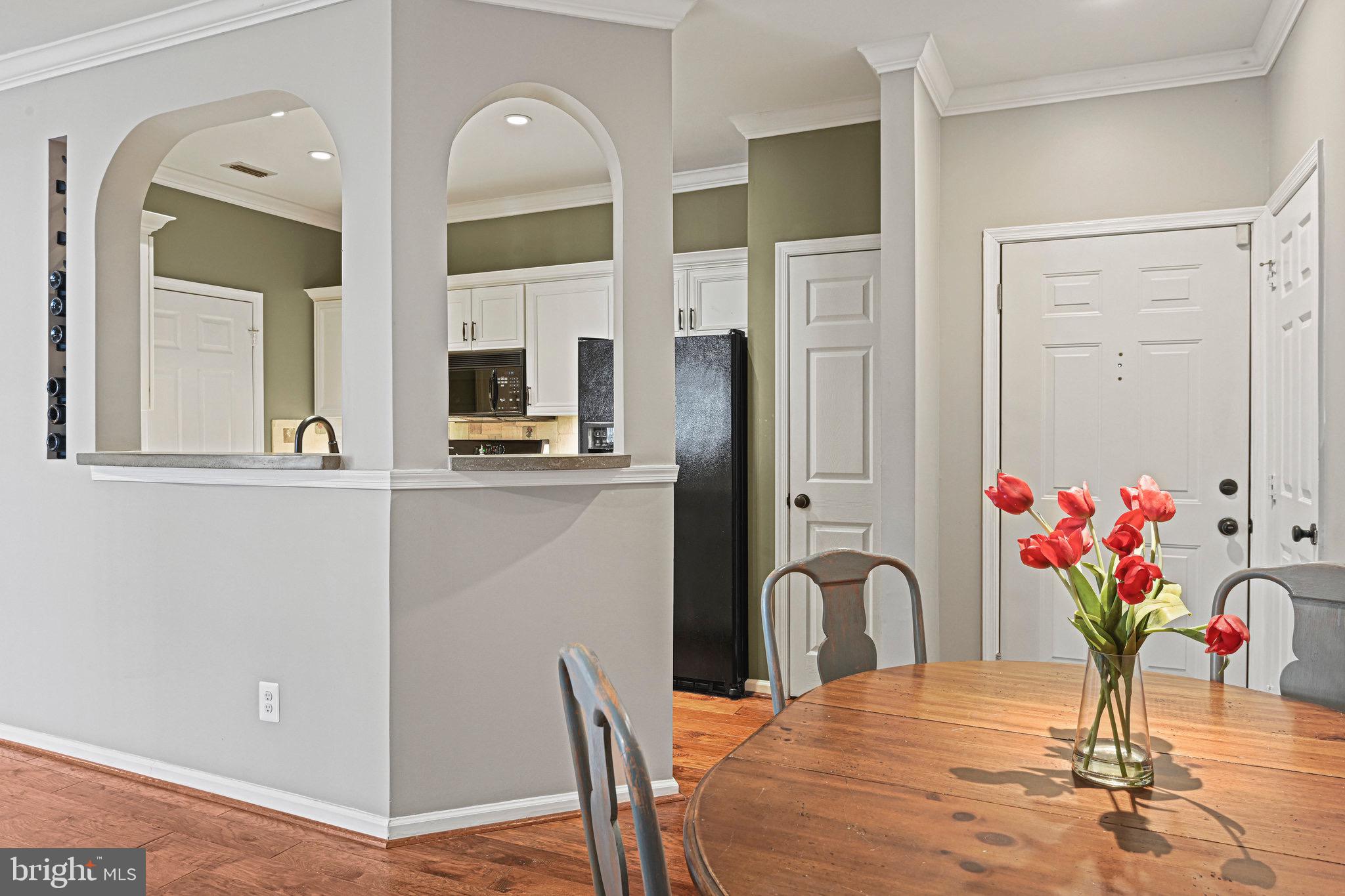 1701 Lake Shore Crest Drive, Unit 24 Reston, VA 20190 - Photo 3 of 43 a view of a dining room with furniture and a potted plant