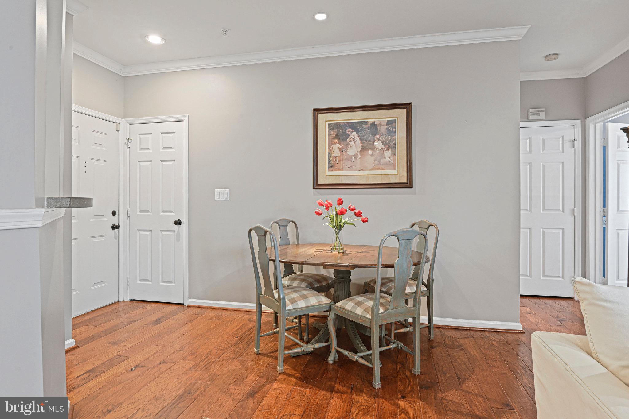 1701 Lake Shore Crest Drive, Unit 24 Reston, VA 20190 - Photo 4 of 43 a view of a dining room with furniture and wooden floor
