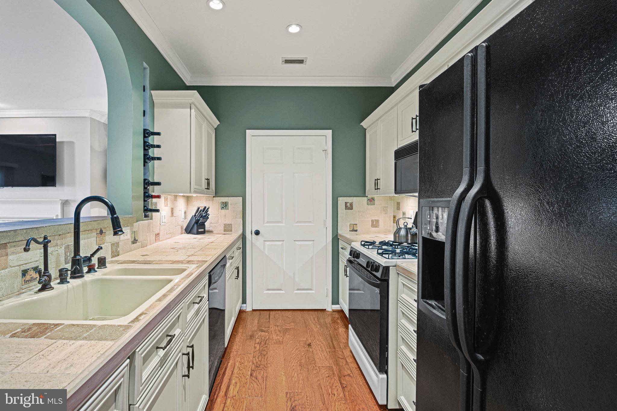 1701 Lake Shore Crest Drive, Unit 24 Reston, VA 20190 - Photo 8 of 43 a kitchen with stainless steel appliances granite countertop a sink stove and refrigerator