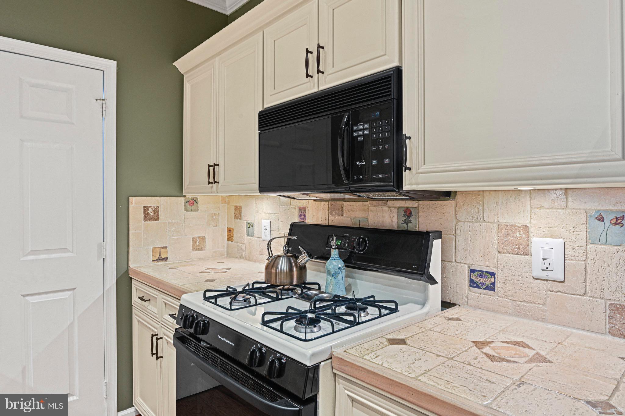 1701 Lake Shore Crest Drive, Unit 24 Reston, VA 20190 - Photo 9 of 43 a stove top oven sitting inside of a kitchen