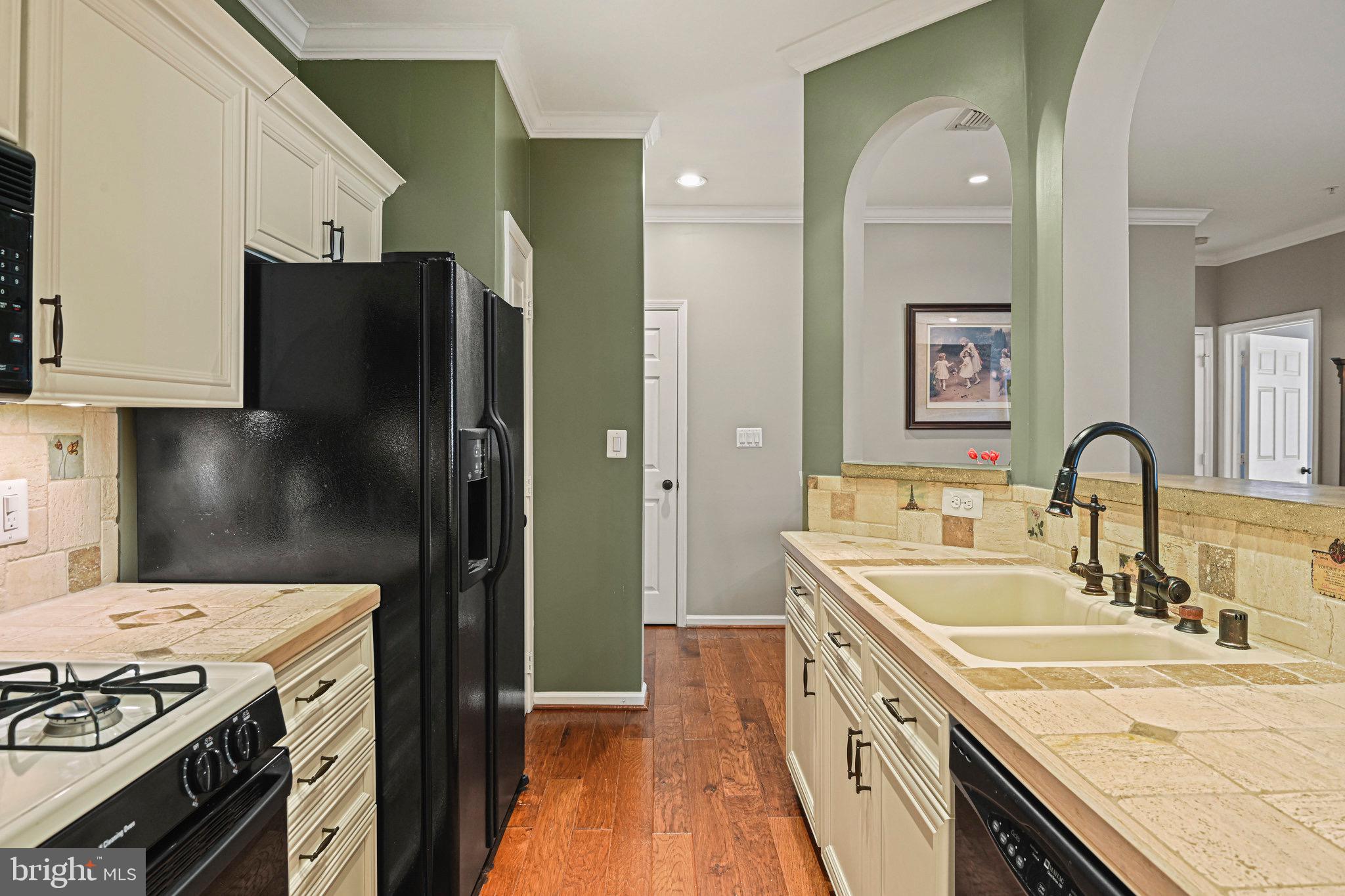1701 Lake Shore Crest Drive, Unit 24 Reston, VA 20190 - Photo 10 of 43 a kitchen with a sink stove and refrigerator