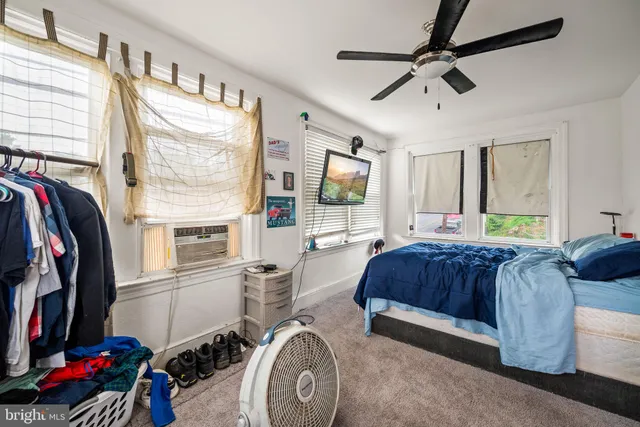 a bedroom with two beds and a dresser