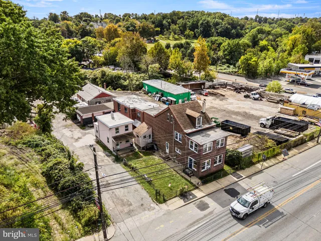 an aerial view of multiple houses with yard
