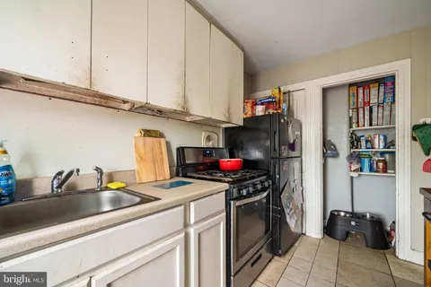 a kitchen with stainless steel appliances a stove a sink and a refrigerator