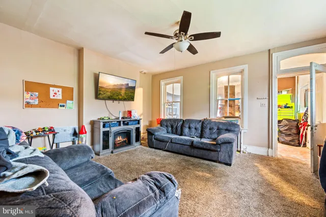 a living room with furniture and a flat screen tv