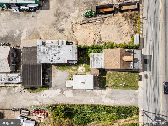 an aerial view of residential houses with outdoor space and street view