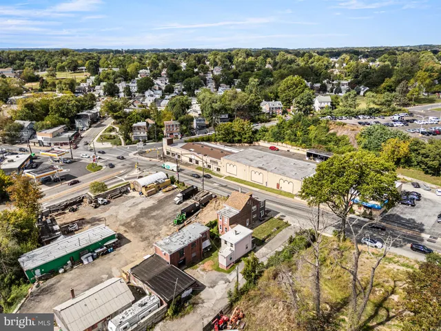 an aerial view of residential houses with outdoor space and trees