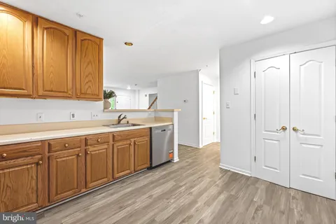 a view of a kitchen with sink and cabinets