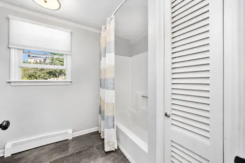 a bathroom with a bathtub and a shower