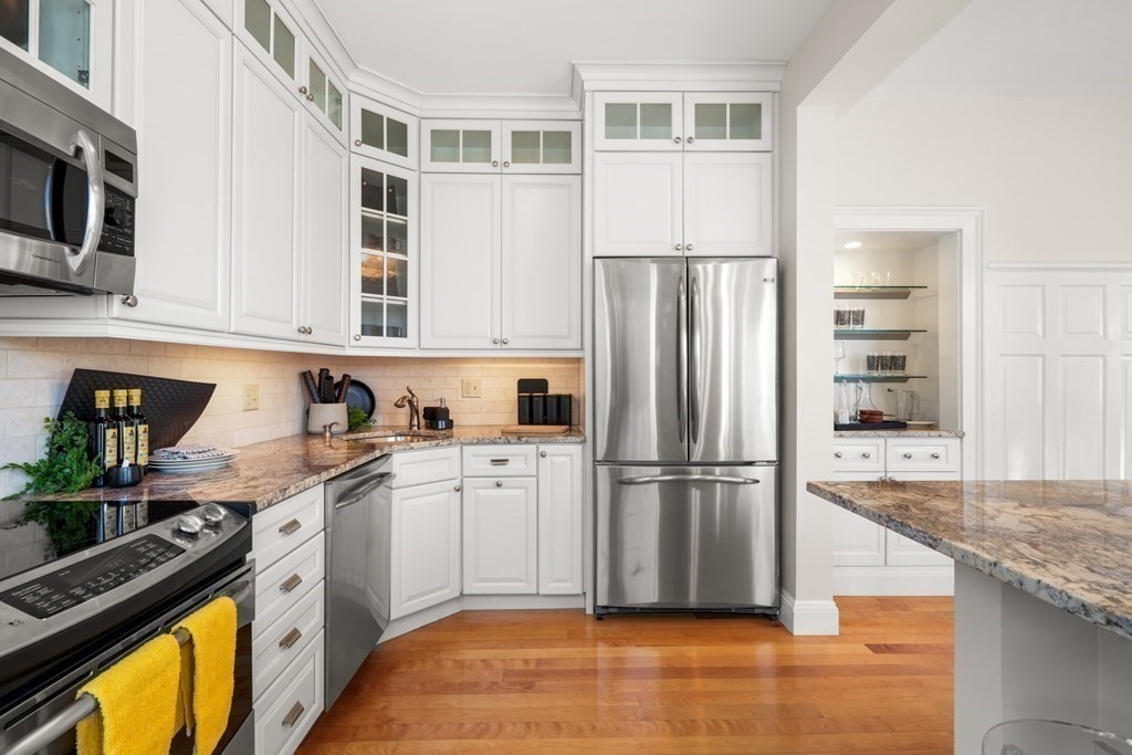 311 Commonwealth Avenue, Unit 41 Boston, MA 02115 - Photo 12 of 31 a kitchen with stainless steel appliances granite countertop a refrigerator a stove and a sink
