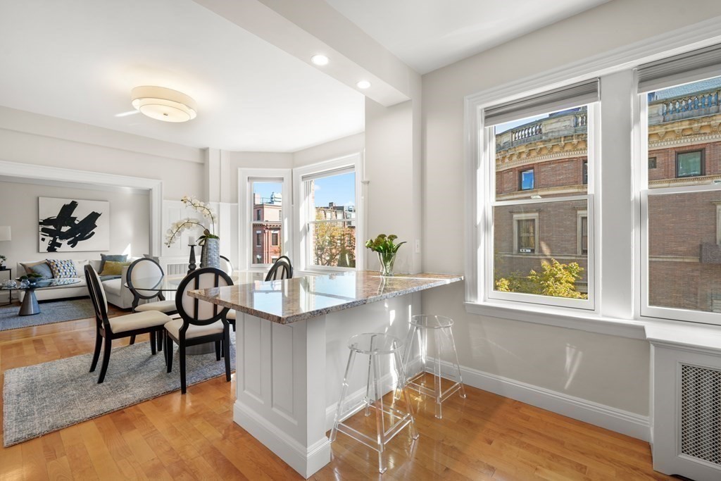 311 Commonwealth Avenue, Unit 41 Boston, MA 02115 - Photo 13 of 31 a living room with kitchen island furniture and a window