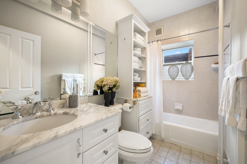 311 Commonwealth Avenue, Unit 41 Boston, MA 02115 - Photo 16 of 31 a bathroom with a granite countertop sink toilet and shower